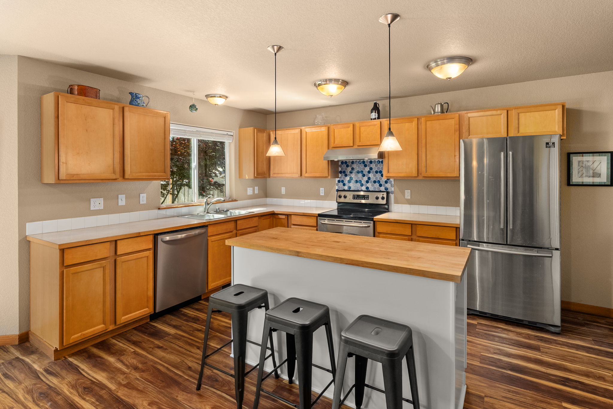 Kitchen offers bar seating, plenty of storage, and a convenient pantry