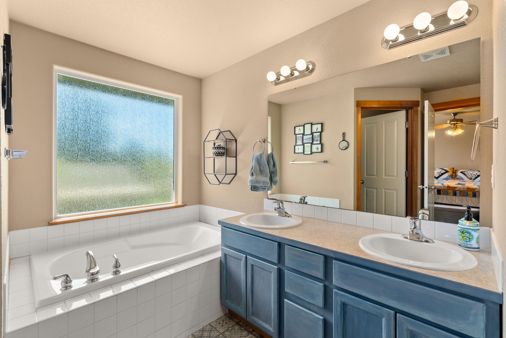 Dual vanities paired with a relaxing soaking tub