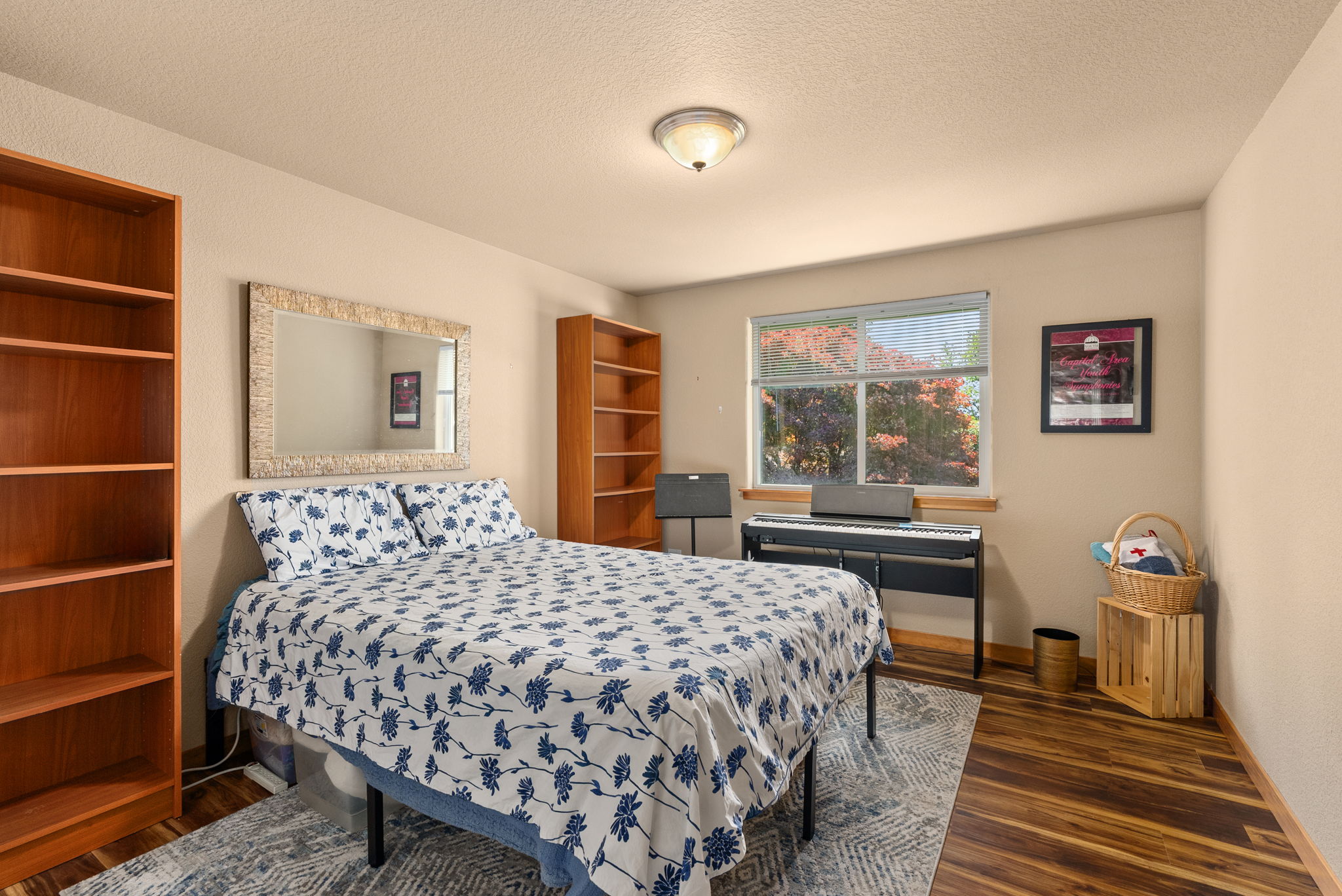 First bedroom upstairs is generously sized with views of the backyard