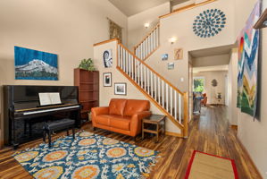 Entry opens to formal living space with soaring ceilings and abundant natural light