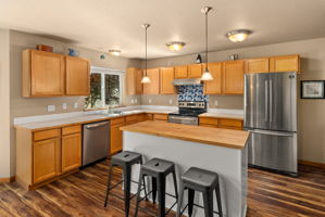 Kitchen offers bar seating, plenty of storage, and a convenient pantry