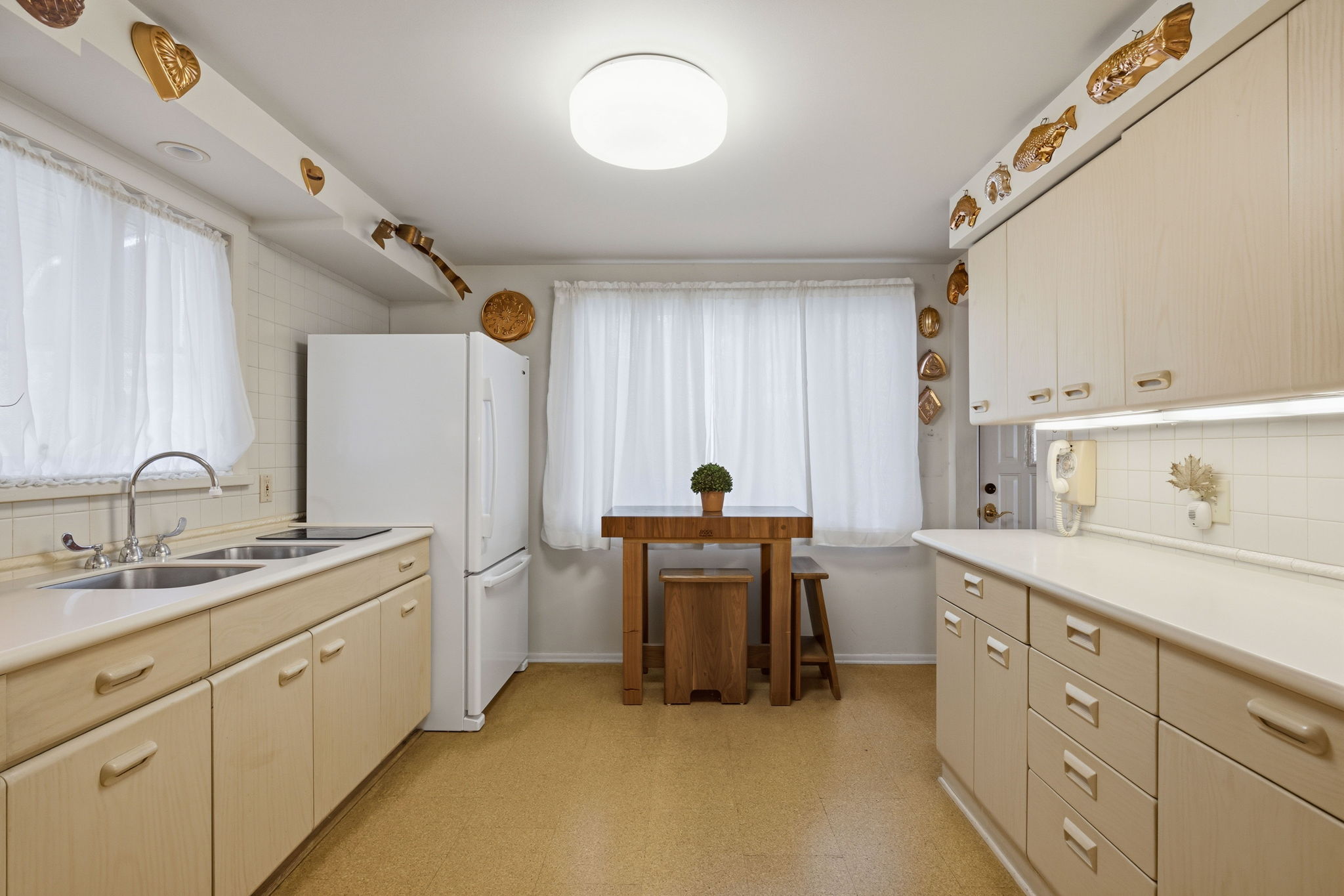Corian countertops and plenty of cabinets, pantry around the corner!
