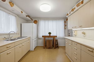 Corian countertops and plenty of cabinets, pantry around the corner!