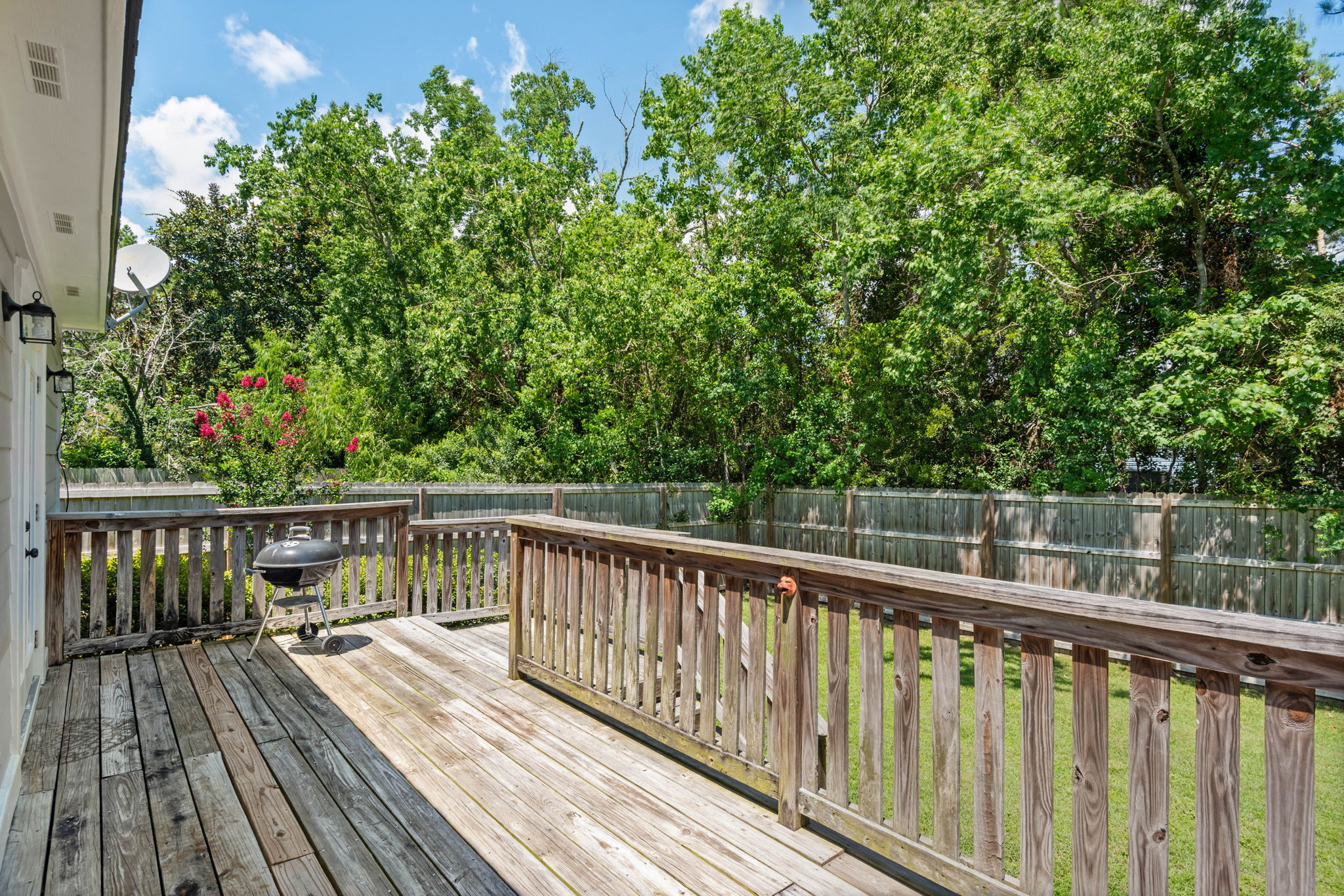Rear deck overlooks nature.