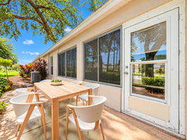 Sunny Suburban Patio with Tropical Landscaping virtually staged.jpeg