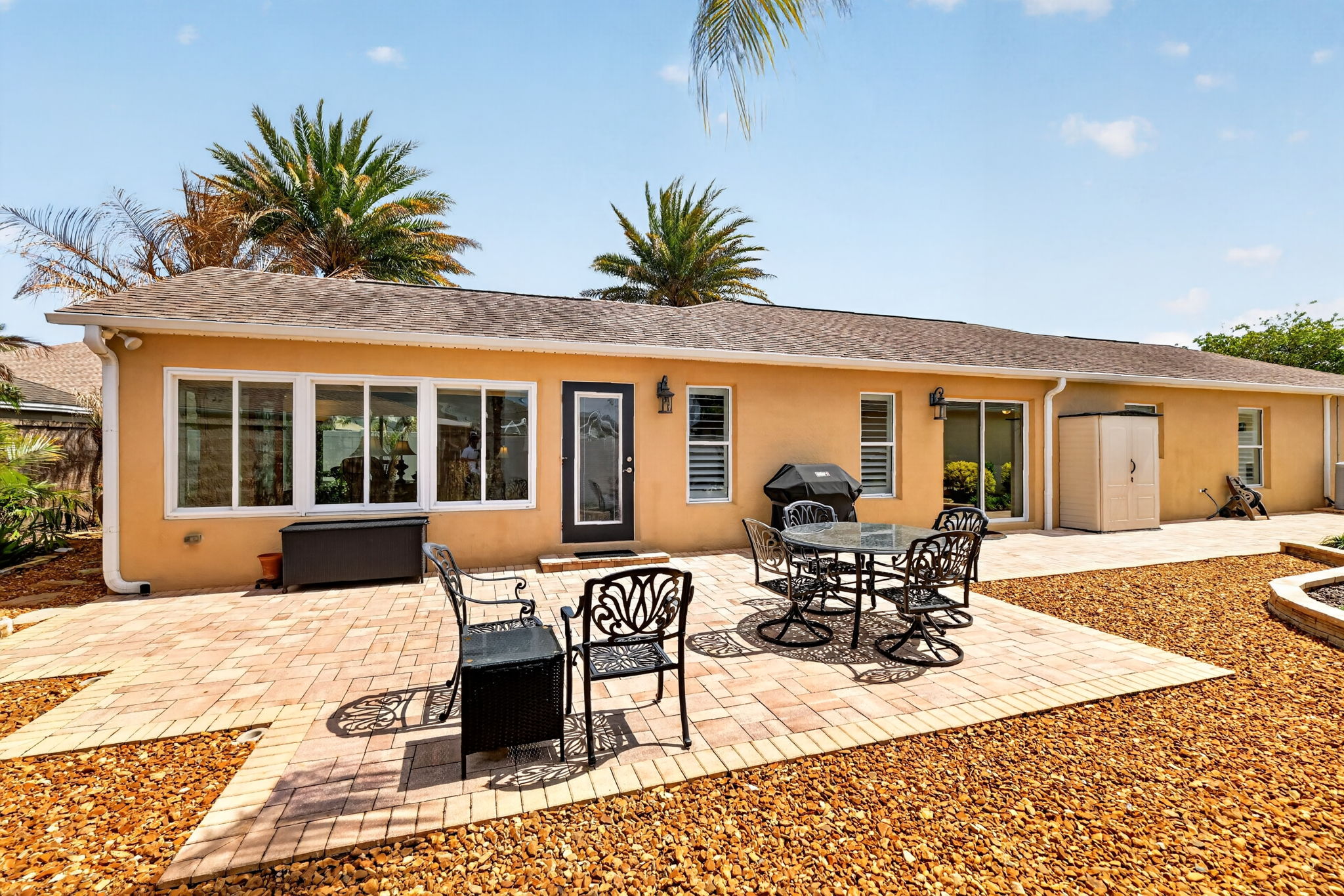 Spacious Side Paver Patio with Enhanced Stoned Hardscaping