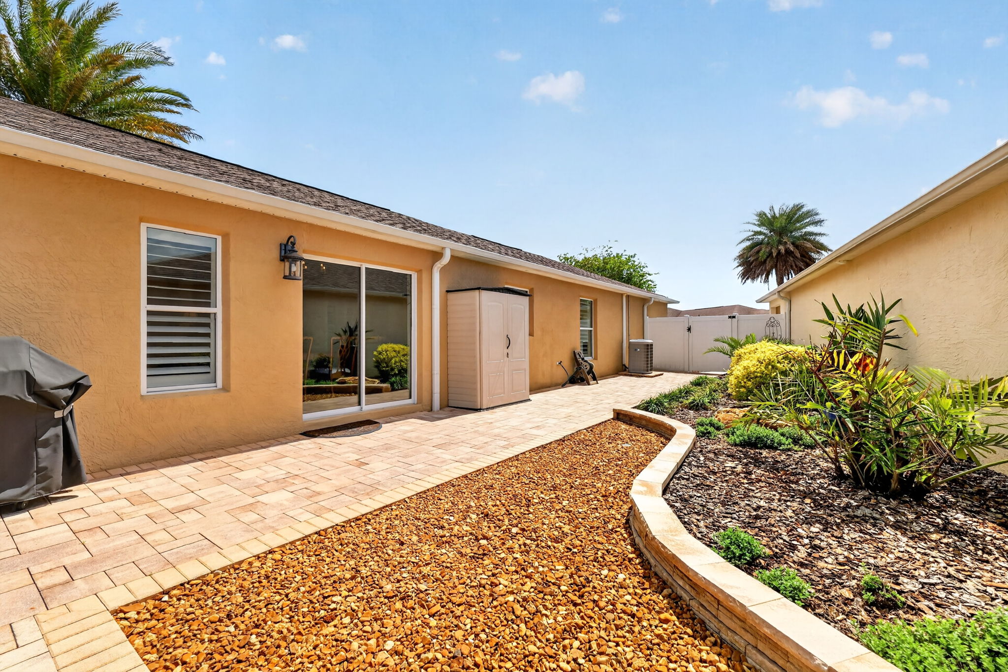 Spacious Side Paver Patio with Enhanced Stoned Hardscaping