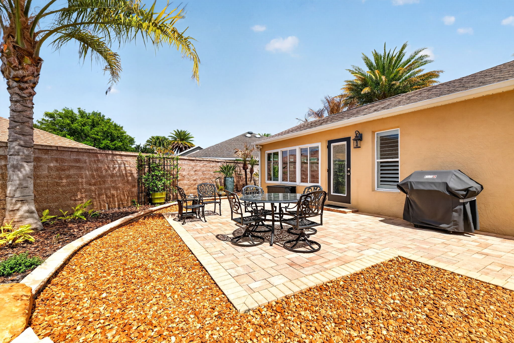 Spacious Side Paver Patio with Enhanced Stoned Hardscaping