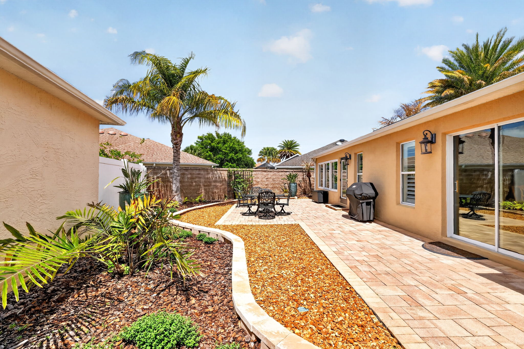 Spacious Side Paver Patio with Enhanced Stoned Hardscaping
