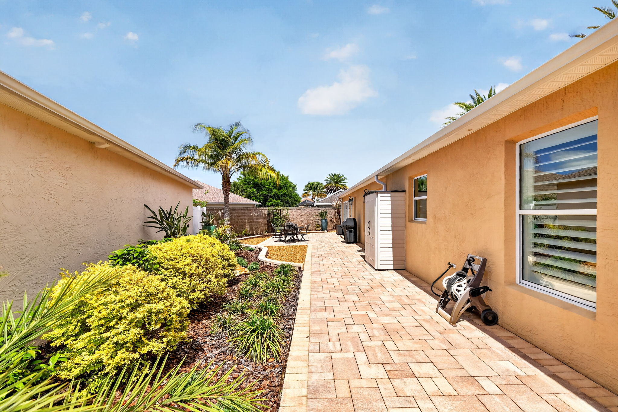 Spacious Side Paver Patio with Enhanced Stoned Hardscaping