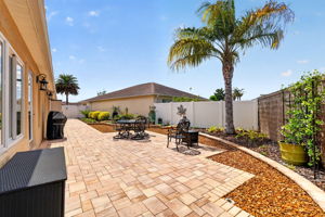 Spacious Side Paver Patio with Enhanced Stoned Hardscaping