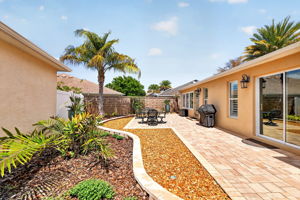 Spacious Side Paver Patio with Enhanced Stoned Hardscaping