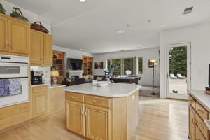 Island kitchen with view to family room and backyard