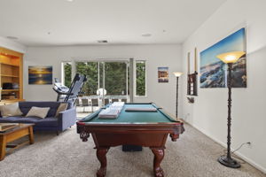 Family room with included pool table overlooks & opens out to backyard