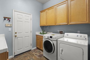 Laundry room & door to 3-car garage. Has both gas and electric dryer connections