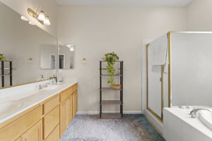 Secondary master bedroom's bath suite with double sink vanity and separate shower & tub