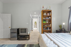 View from secondary master bedroom towards its closets, private commode area and bath suite