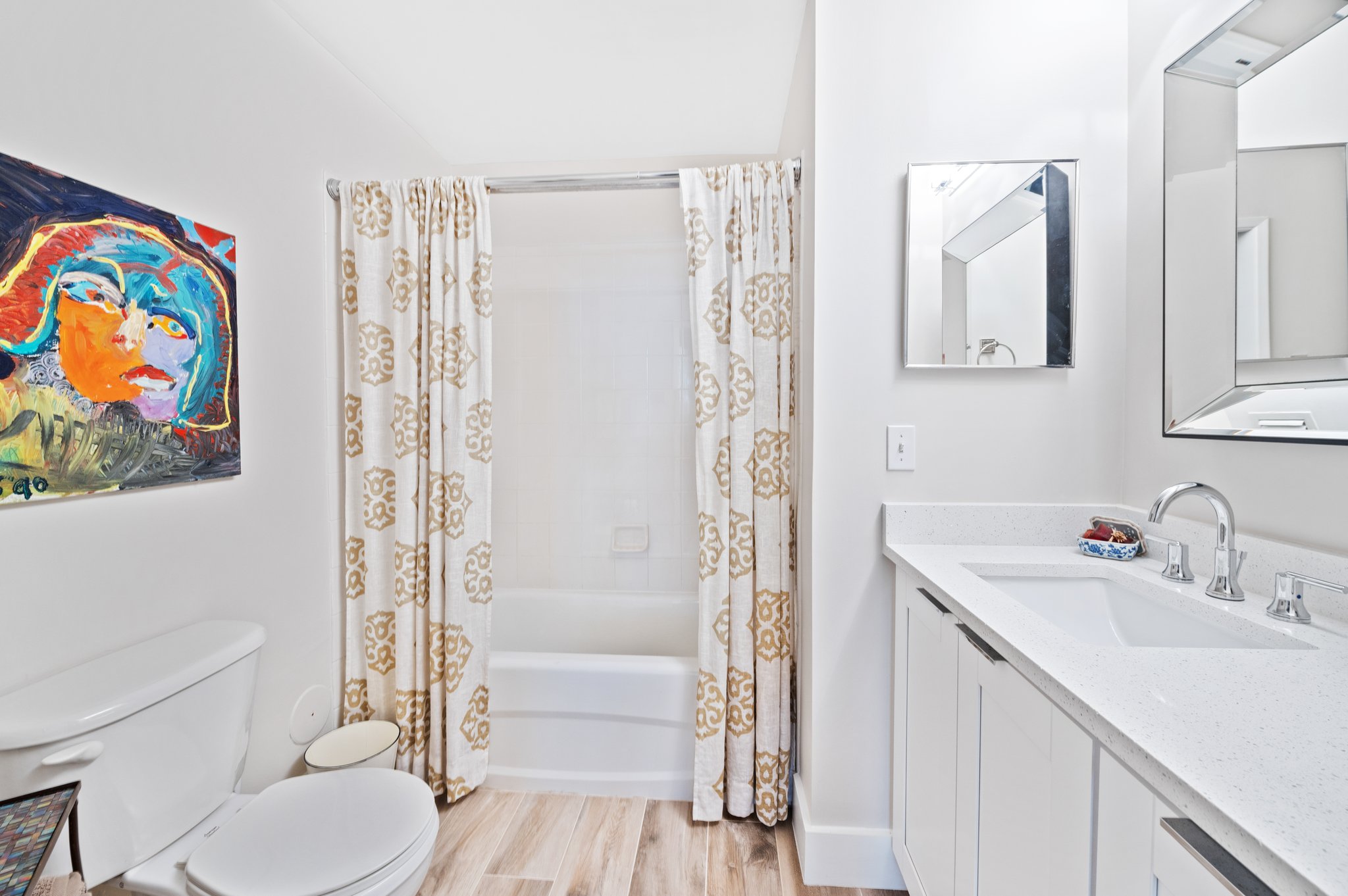Guest bathroom is spacious and updated including quartz vanity