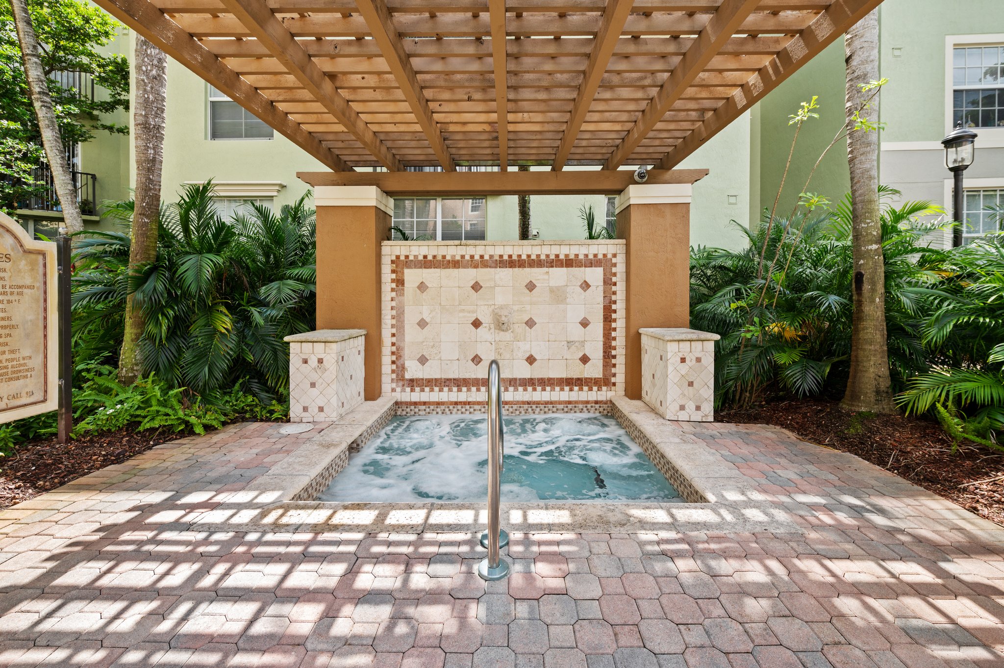Pergola covered spa by the pool
