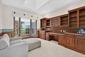 OFFICE/DEN/FLEX HAS CUSTOM BUILT-IN DESK & CABINTRY WITH A BEAUTIFUL BAY WINDOW ADDING LIGHT & SPACE
