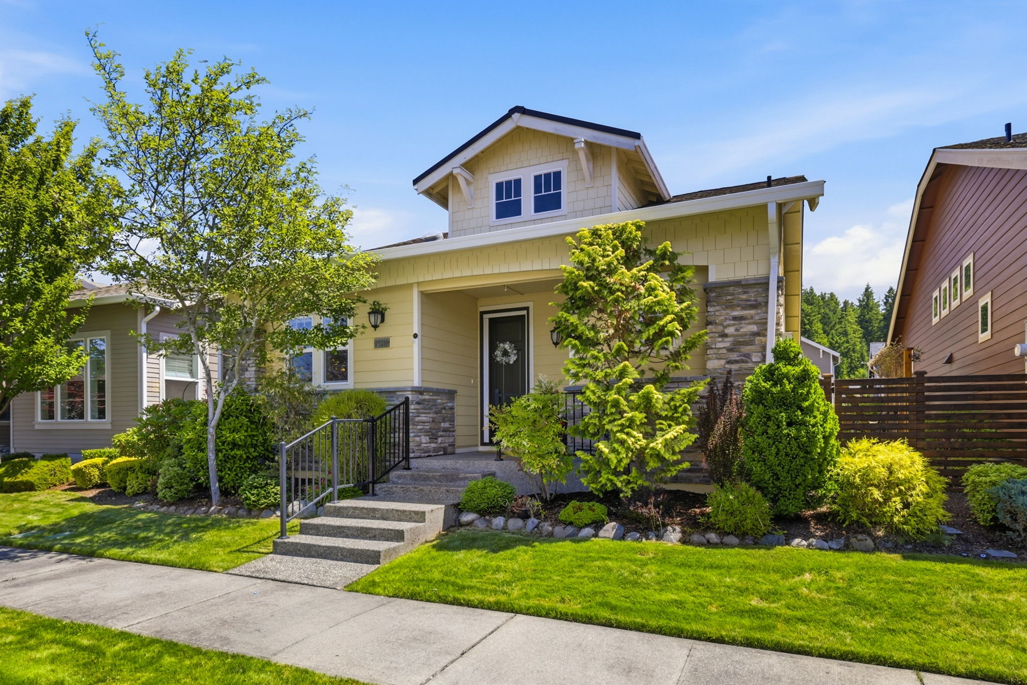 Front Exterior. Classic architectural details and layered landscaping create inviting curb appeal.