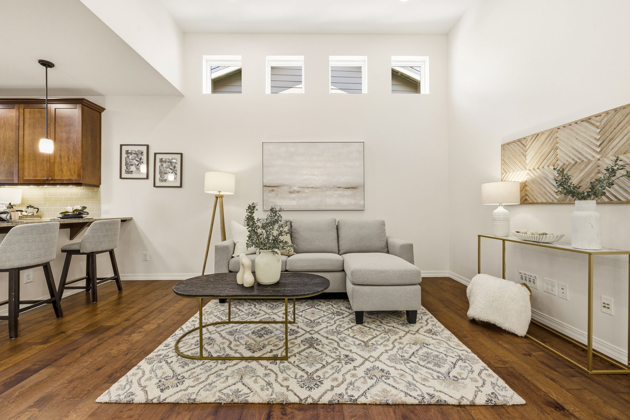 Living Room. Open sightlines connect the living area to the kitchen and dining space beyond, ideal for entertaining.