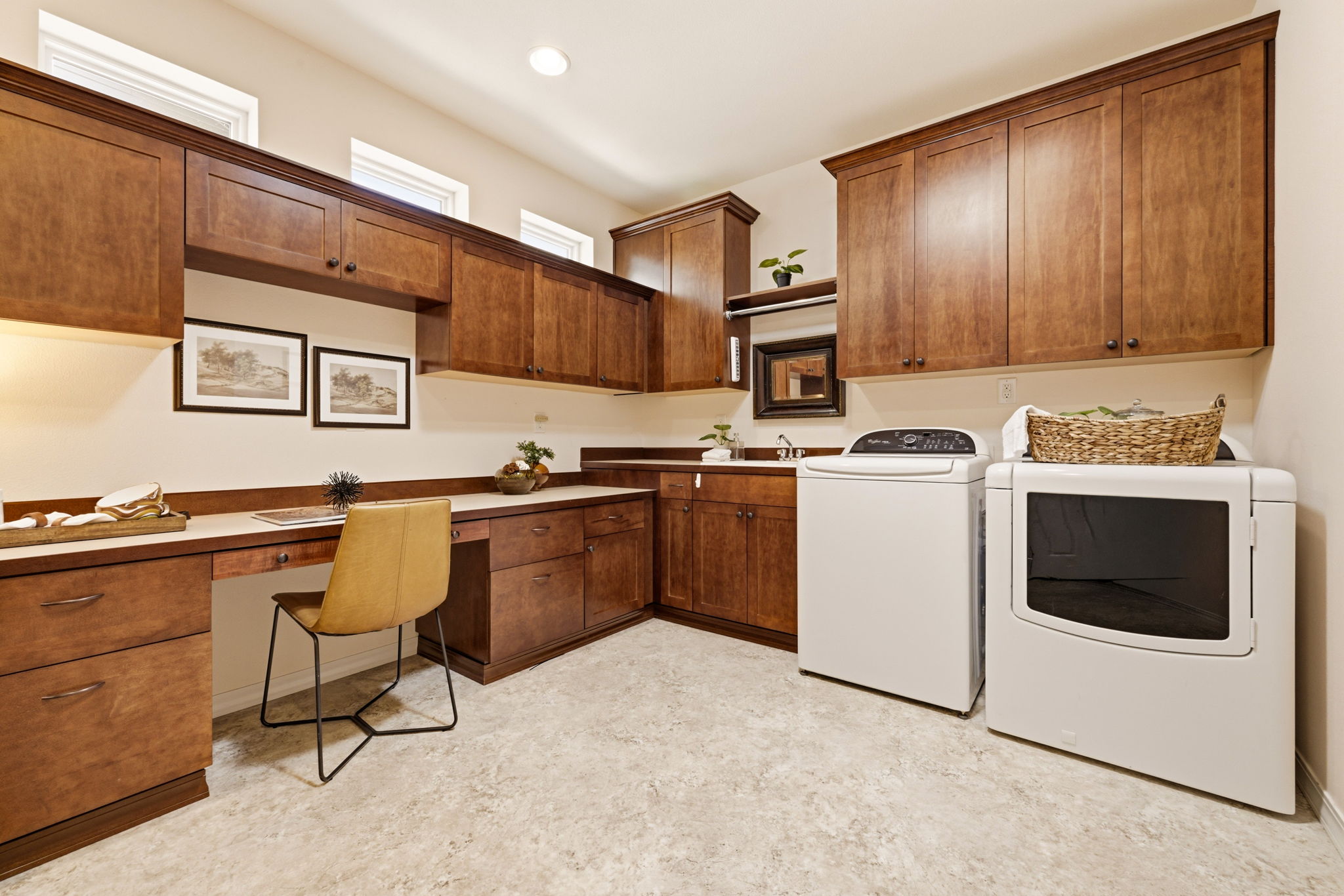 Laundry Room. Abundant cabinetry and counter space offer a functional area for laundry and everyday organization.