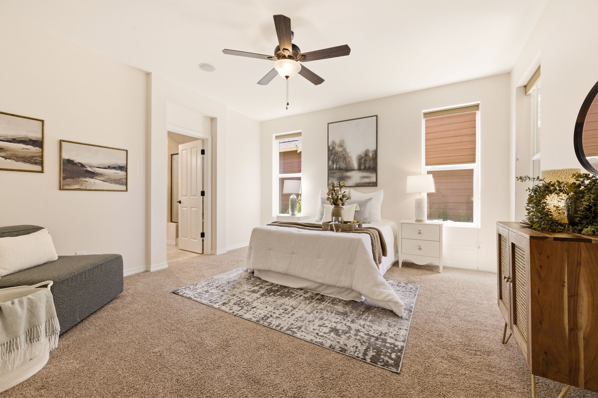 Primary Bedroom. A generous layout with plush carpet and a cozy sitting area provides a private retreat.