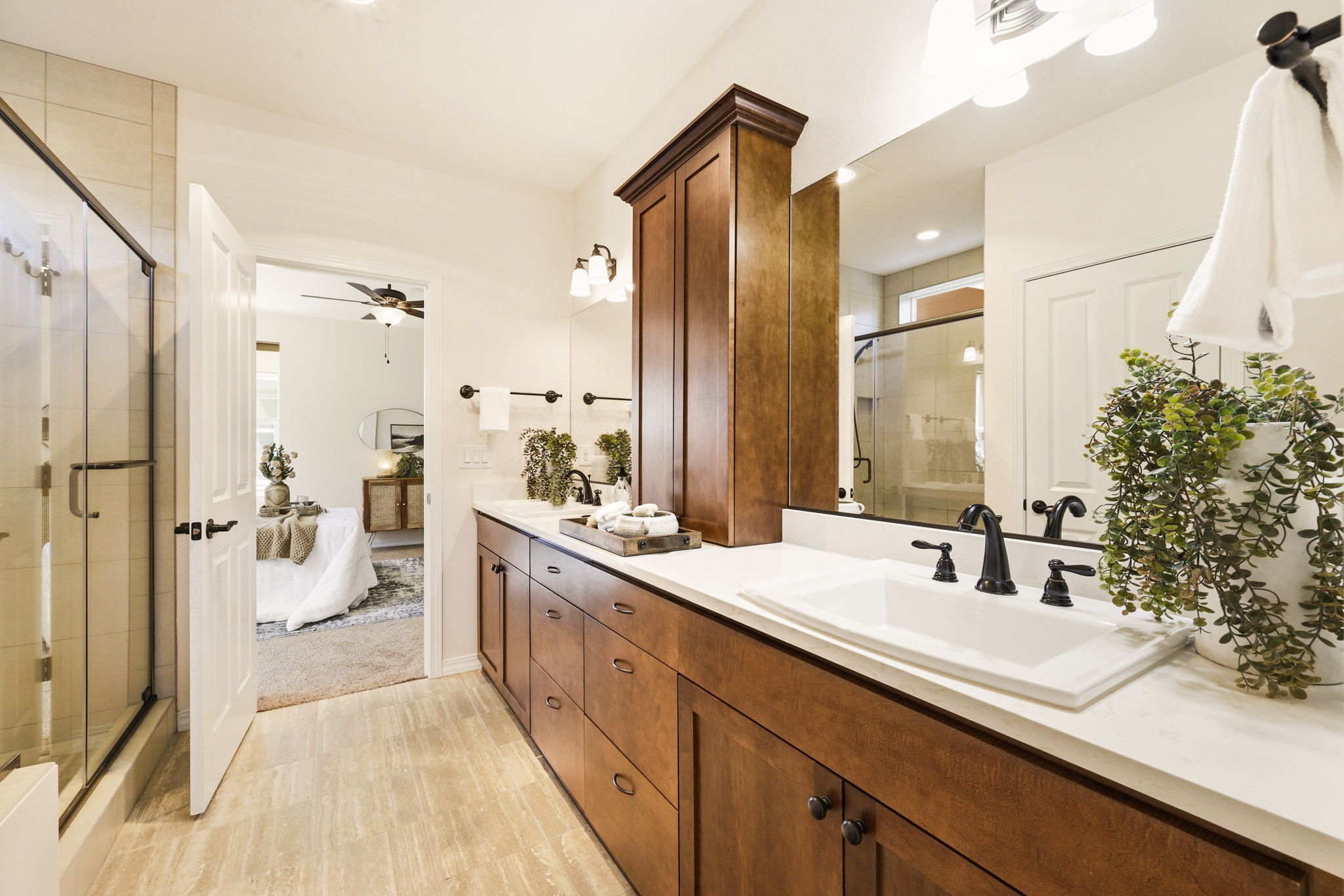 Primary Bathroom. A glass-enclosed shower and dual vanity create a spa-like feel just steps from the bedroom.