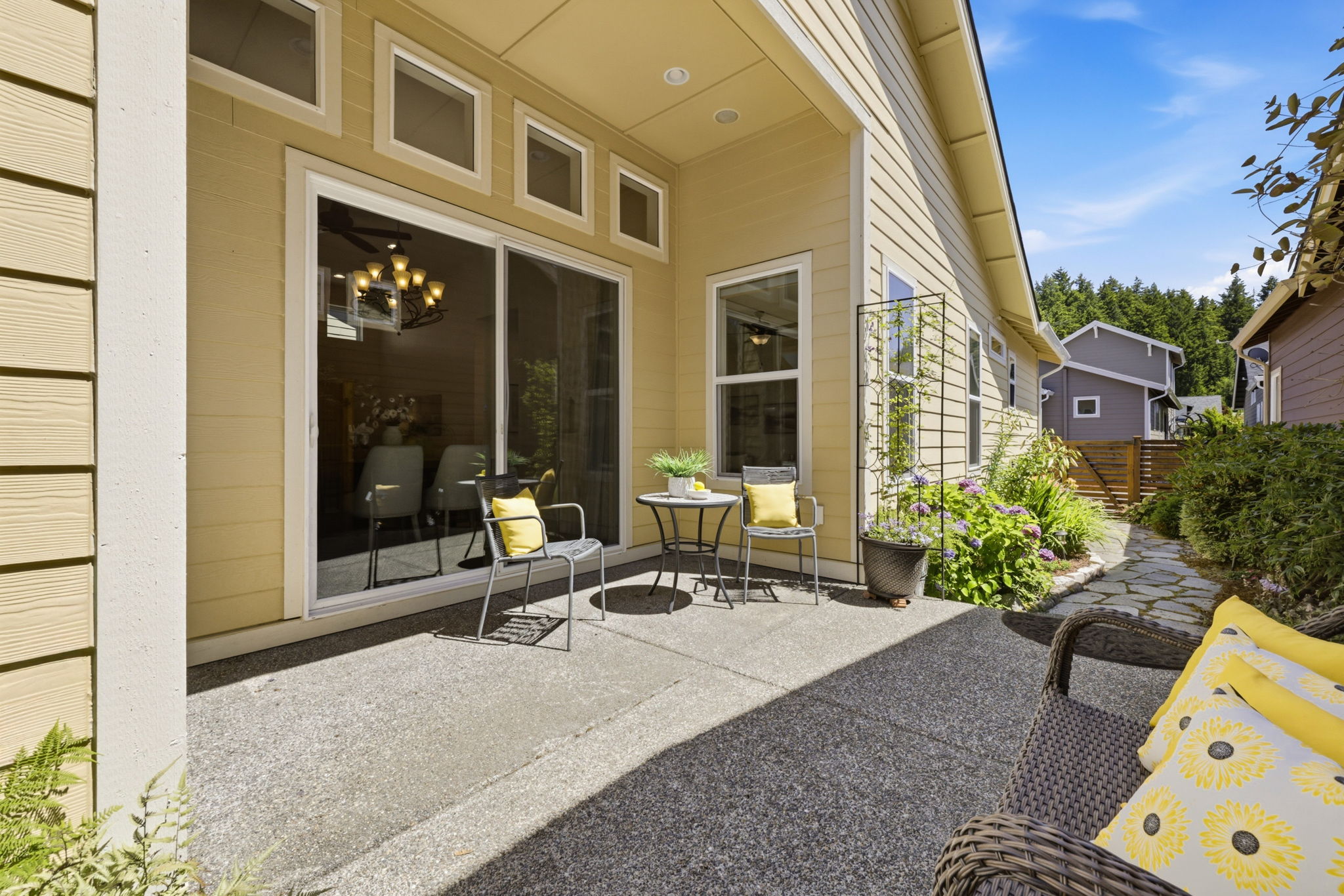 Covered Patio. A shaded outdoor living space with seating for dining and relaxing year-round.