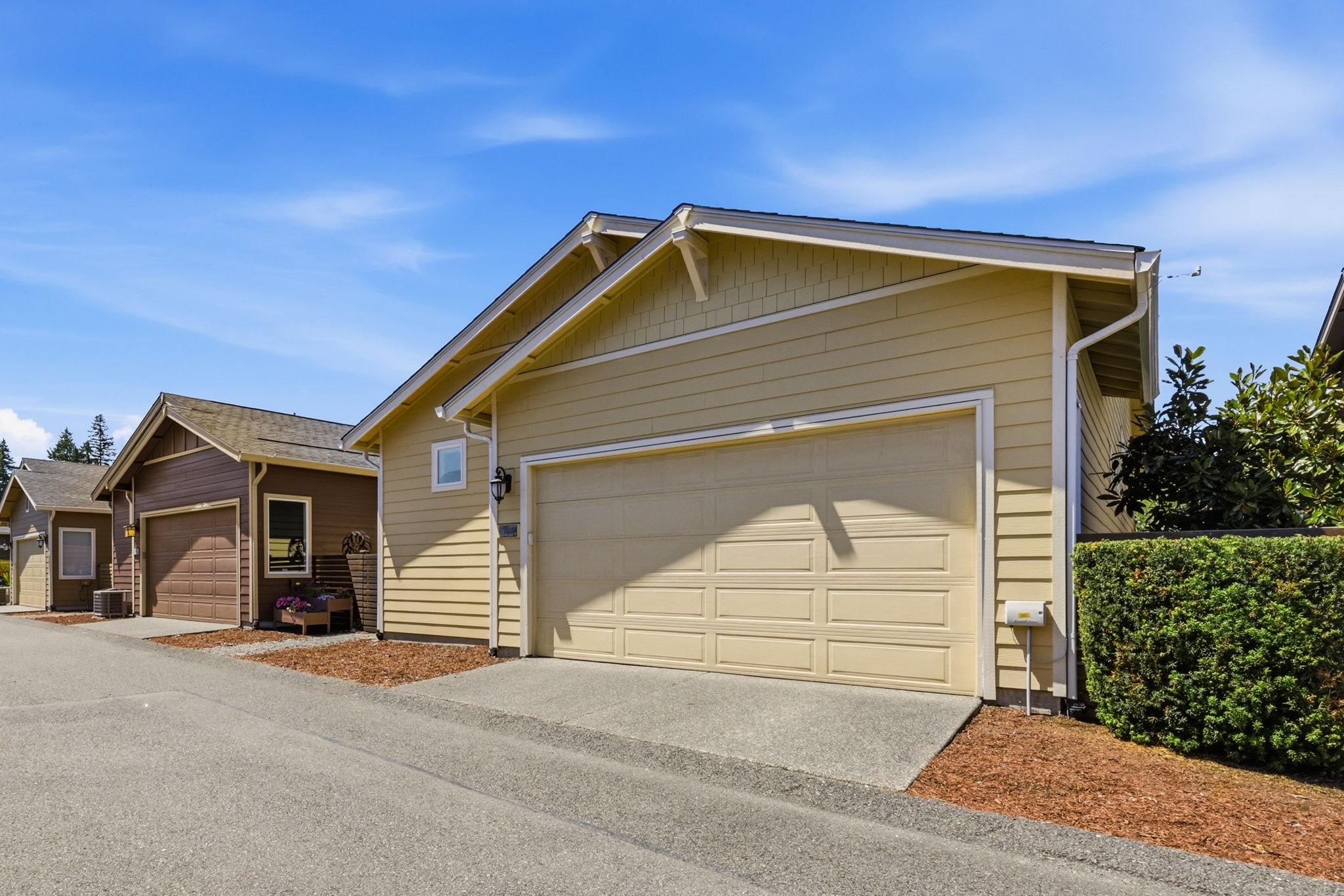 Exterior. The attached garage and paved driveway provide convenient parking and storage.