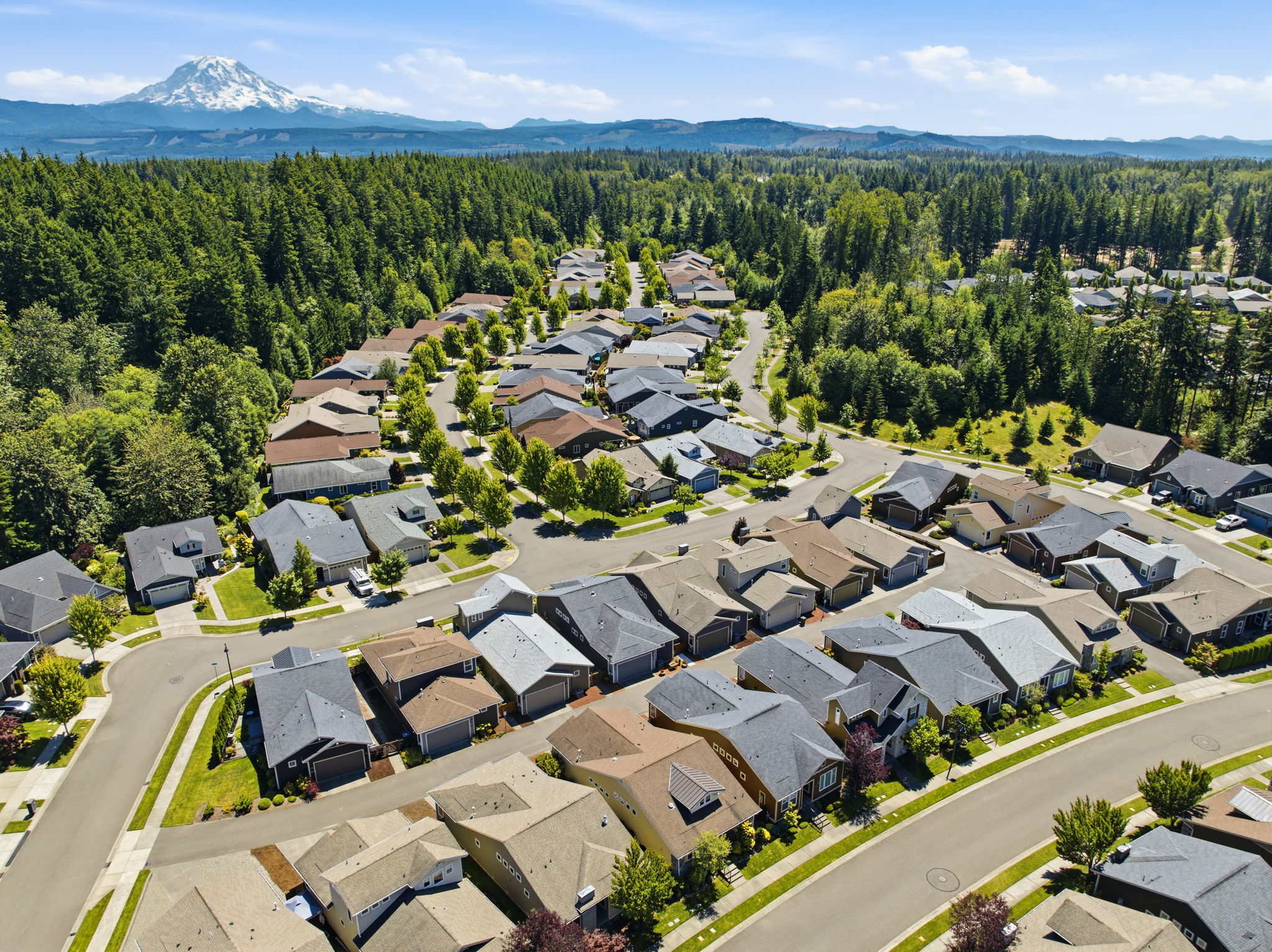 Aerial View. Sweeping Mount Rainer views rise above the tree-lined community.