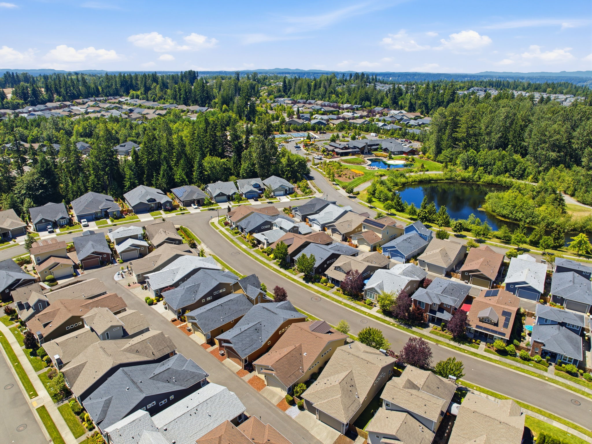 Aerial View. A community pond and lush landscaping add scenic charm to the neighborhood.