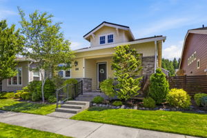 Front Exterior. Classic architectural details and layered landscaping create inviting curb appeal.