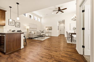 Great Room. Soaring vaulted ceilings with clerestory windows fill the open-concept living, dining, and kitchen space with natural light, perfect for everyday living and entertaining.