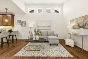 Living Room. Open sightlines connect the living area to the kitchen and dining space beyond, ideal for entertaining.