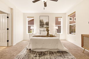 Primary Bedroom. Dual windows fill the space with natural light, framing a spacious layout with room to unwind.