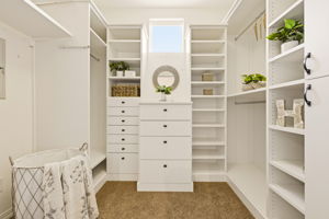 Walk-in Closet. Custom built-in shelving and drawers provide organized storage tailored to fit any wardrobe.