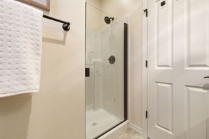 Bathroom. A glass-enclosed shower with tile surround offers a clean, modern finish.