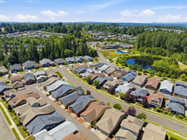 Aerial View. A community pond and lush landscaping add scenic charm to the neighborhood.