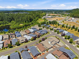 Aerial View. Open green space and wooded hillsides surround the neighborhood.