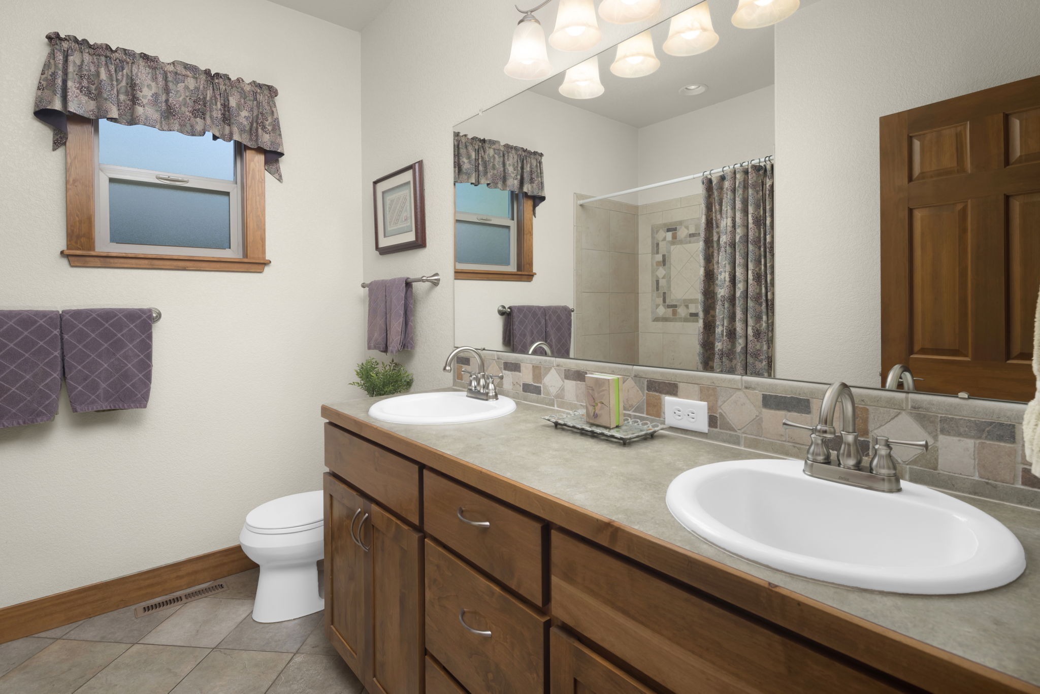 Guest Bathroom Features Dual Sinks and Nice Tile Details