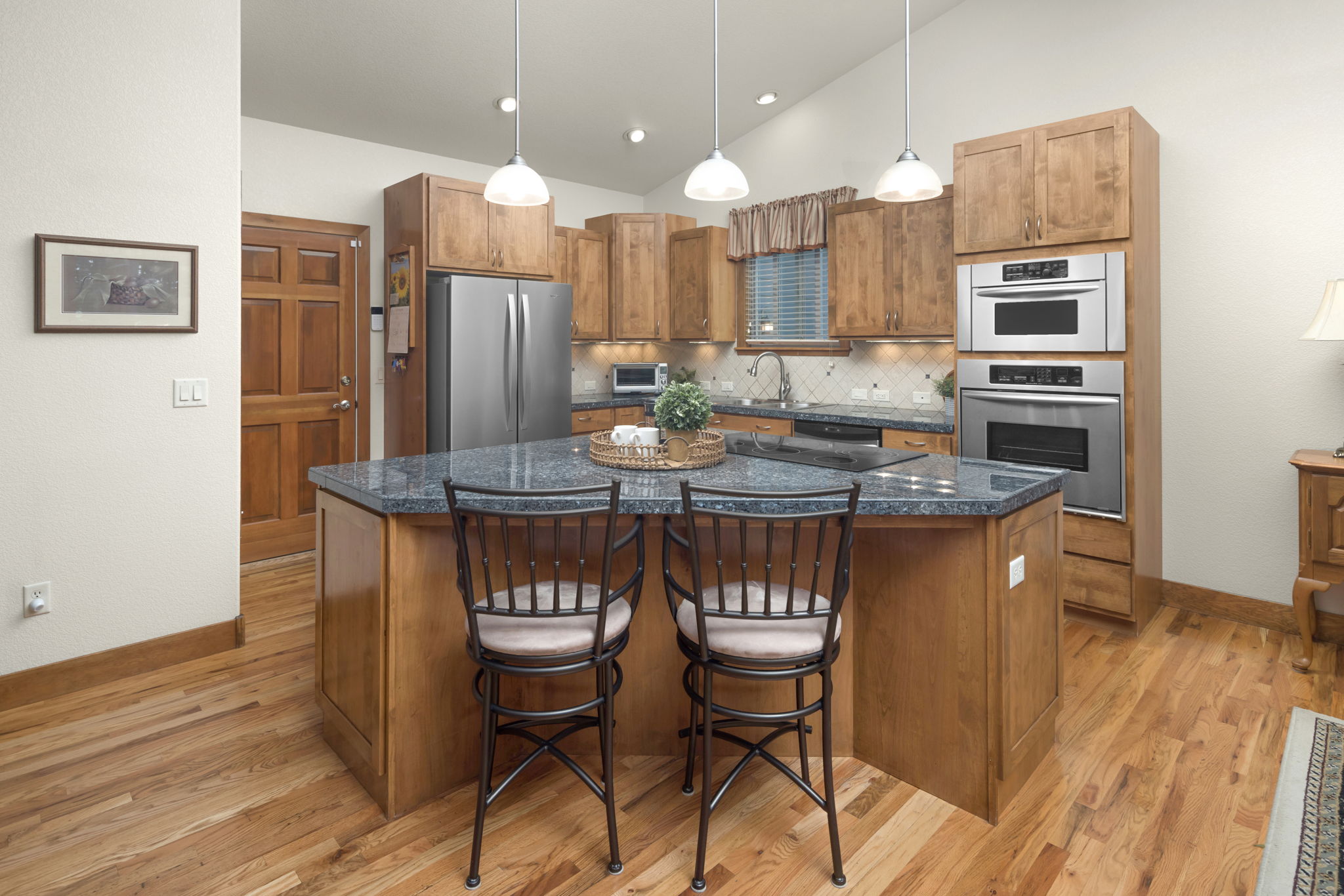 Bright Open Kitchen Features All SS Appliances and Pantry