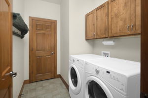 Cabinets Provide Storage Space in Laundry Room