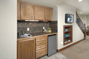 Mini Fridge (included) and Wet Bar With Tile Surround