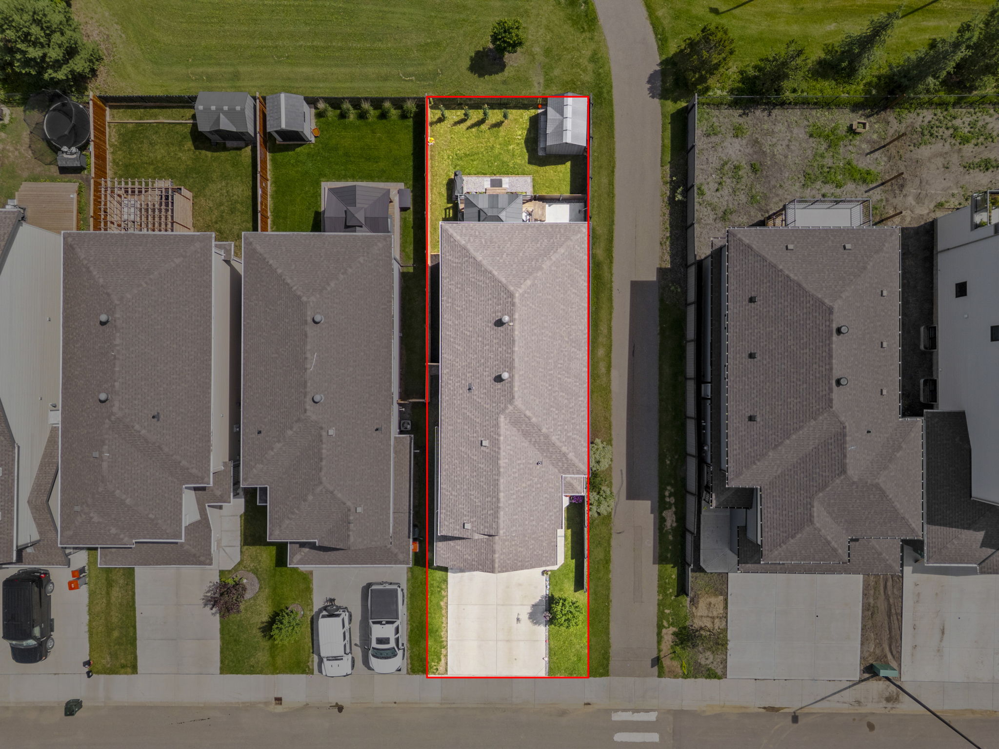 Overhead property image with the featured home highlighted against dimmed neighbouring lots.