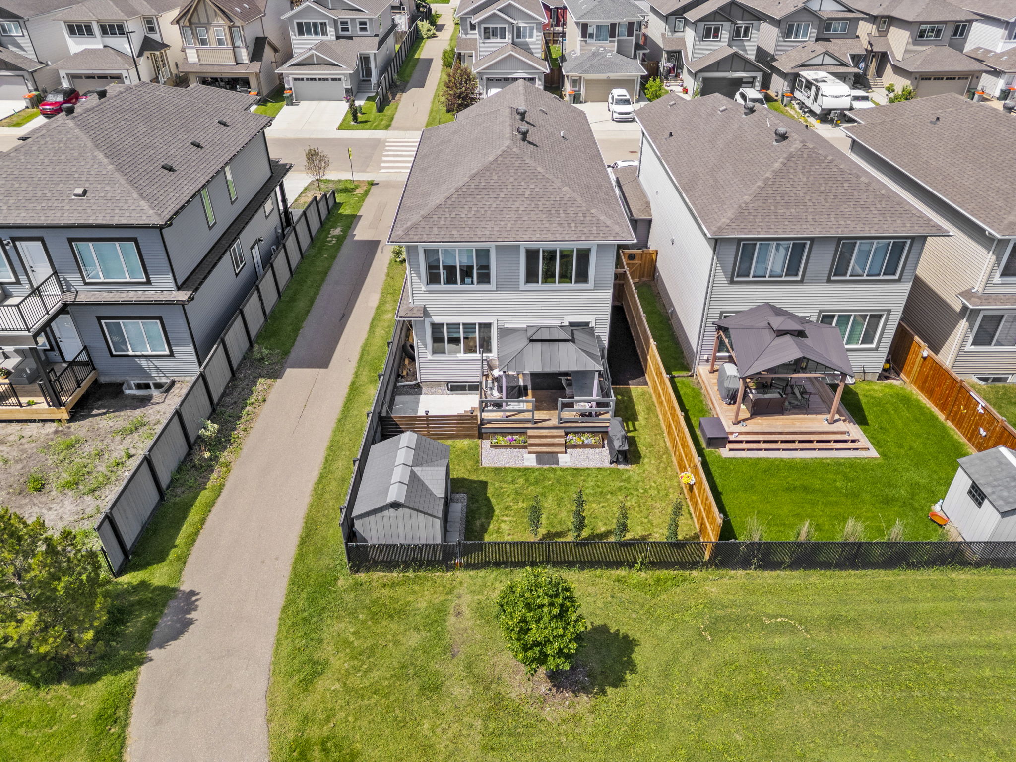 Elevated rear view of the Westerra Lane home, raised deck and fenced lawn.