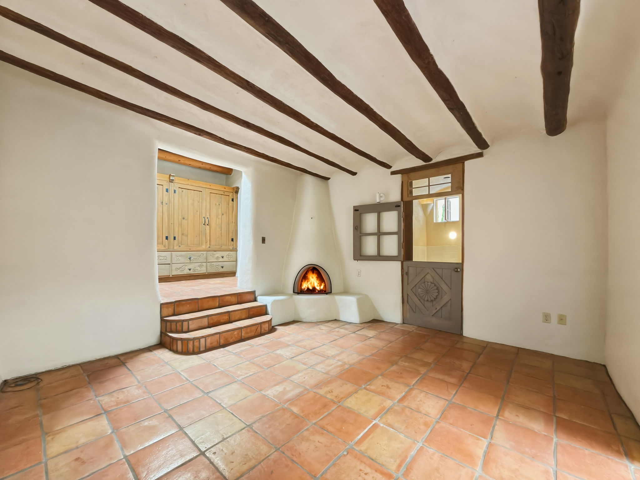 Spacious Primary suite with a kiva wood-burning fireplace and generous wardrobe space.
