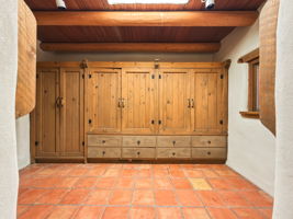 Primary suite dressing area featuring hand-carved drawer cabinetry.