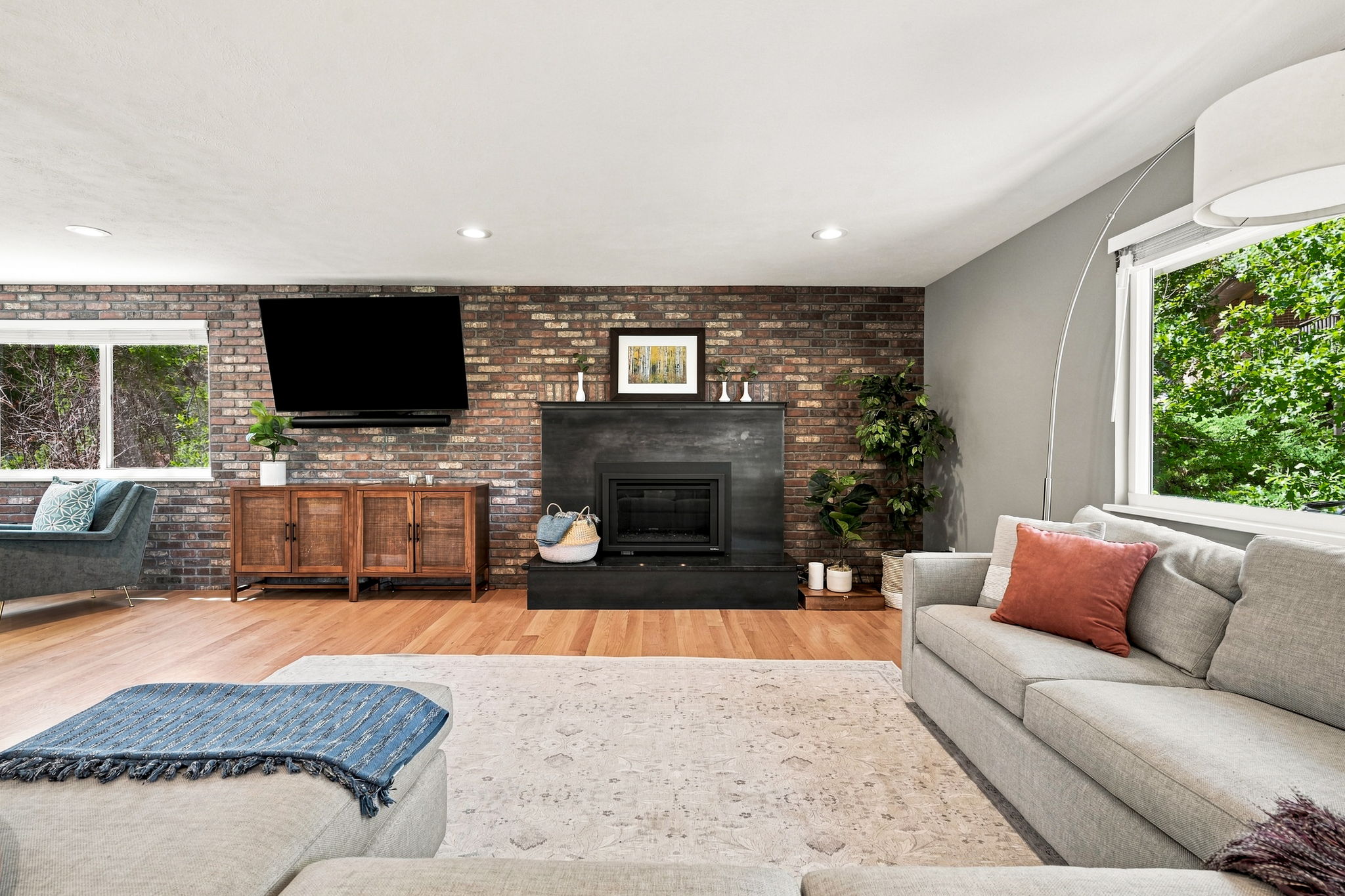 Living room anchored by a fireplace converted to gas for everyday use.